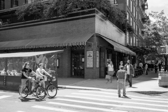Busy city street intersection with cyclists and pedestrians