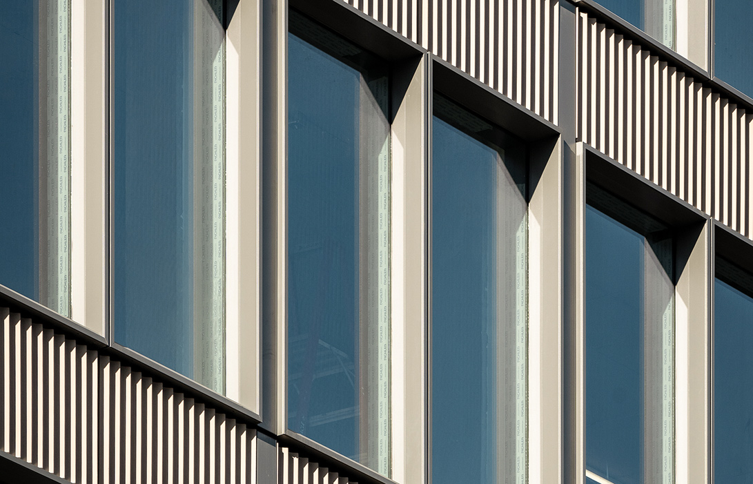 Top 3 stories of 360 Bowery with neatly lined windows